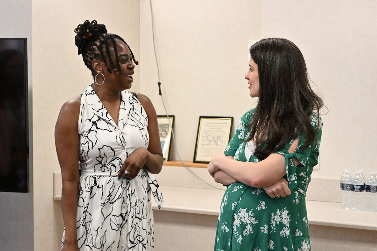 Two students discussing the MA in Global Risk program with an advisor