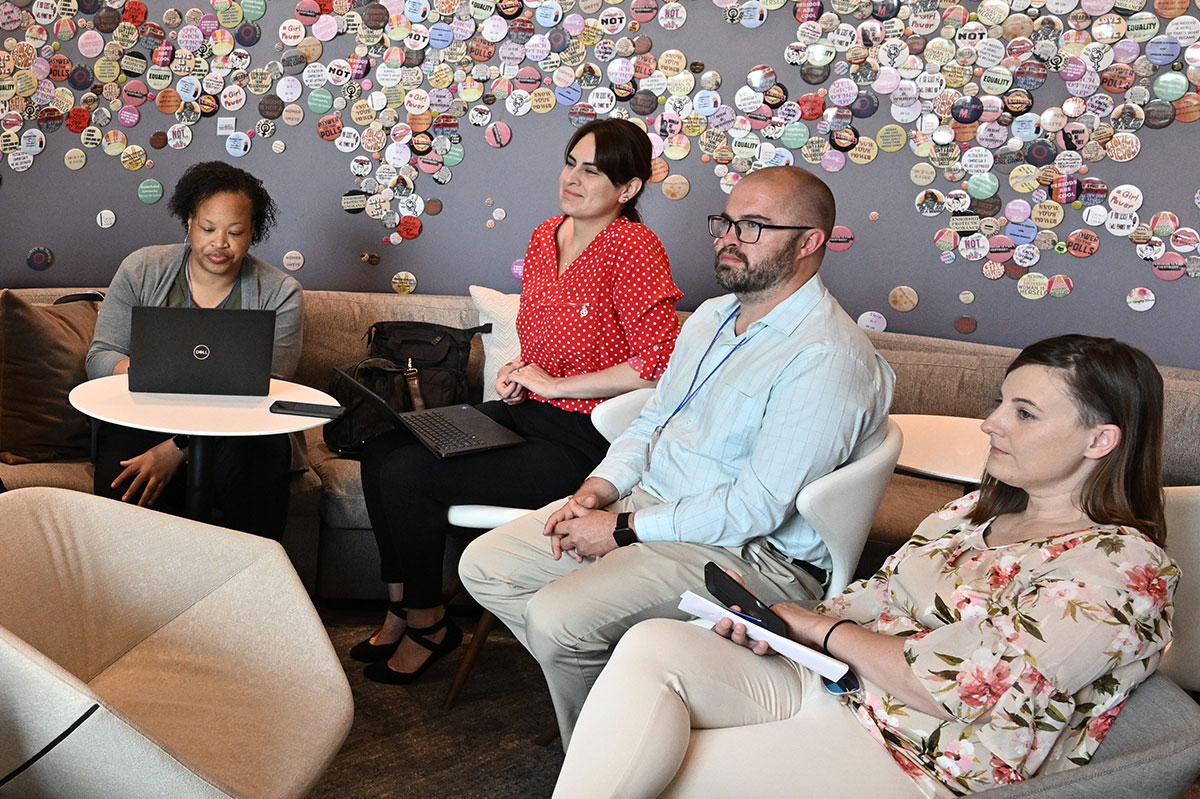 Group of SAIS students at a meeting with laptops